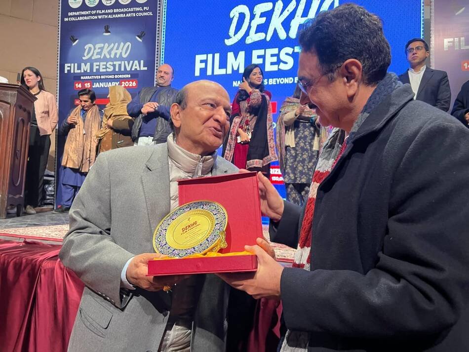A DEKHO Film Festival commemorative shield being presented to a guest of honour